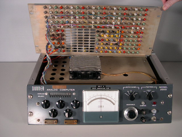  image of A view of the underside of the the Donner 3500 analog computer's patchboard.  You can also see the fan (covered by a screen) and the oblong openings that were used to dissipate the heat from the tubes. 